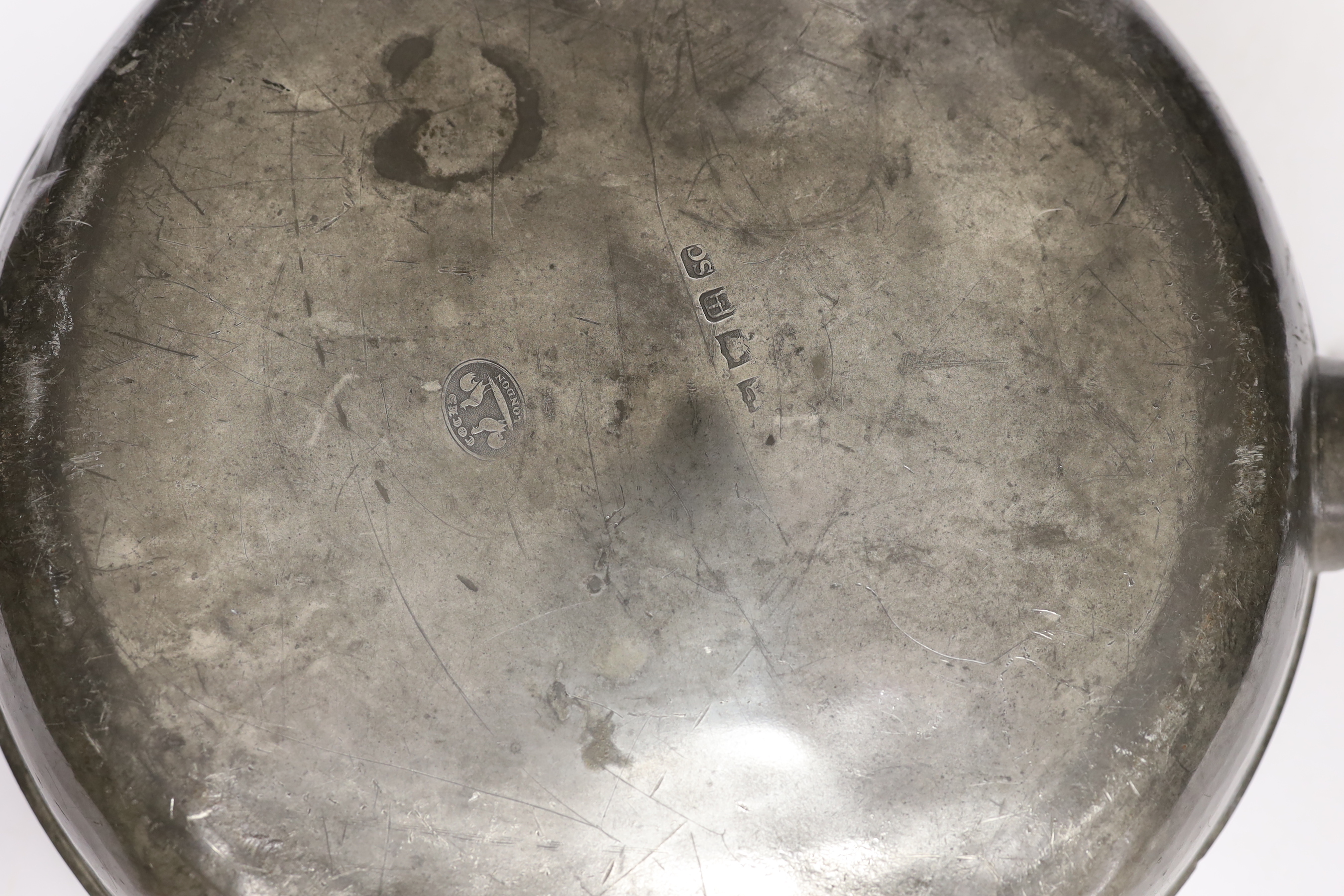 An 18th/19th century pewter measure and an 19th century pewter pan, 46cm long
